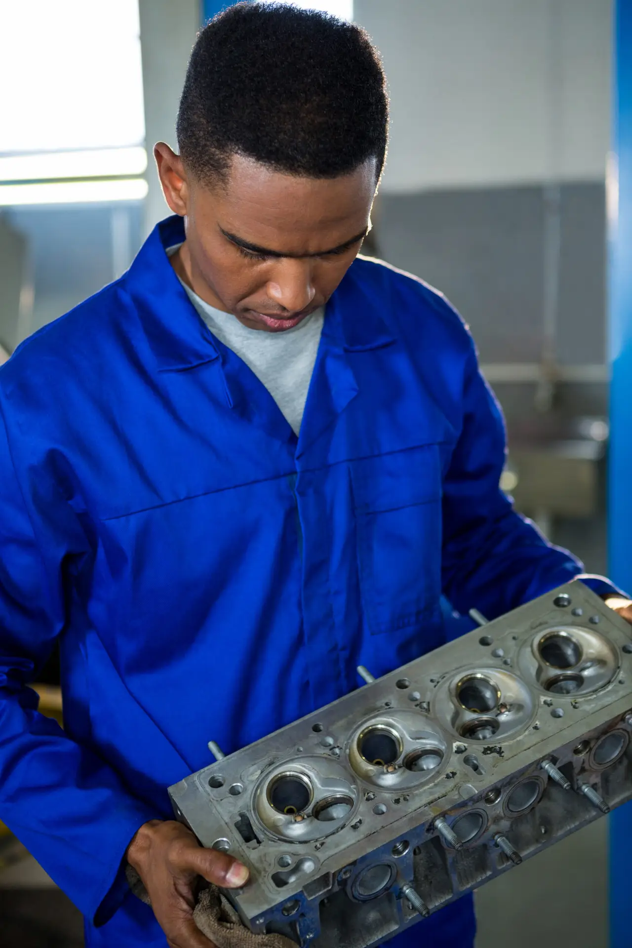 Mechanic examining a car parts in repair garage